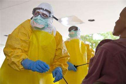  In this Monday, Oct. 6, 2014, file photo, licensed clinician Hala Fawal practices drawing blood from a patient using a dummy in Anniston, Ala. A laboratory technician at the Centers for Disease Control and Prevention is being monitored Wednesday for possible accidental exposure to the Ebola virus that came during an experiment, officials said. The person working in a secure laboratory in Atlanta may have come into contact with a small amount of a live virus, CDC spokeswoman Barbara Reynolds said in an emailed statement. (AP Photo/Brynn Anderson)